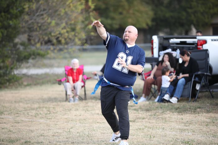 A quarterback follows through on a throw