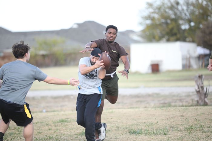 A receiver catches the ball in traffic