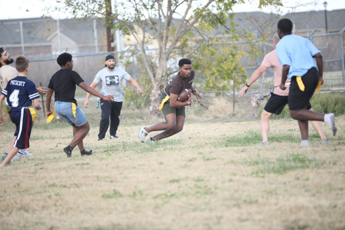 A runner carries the ball upfield