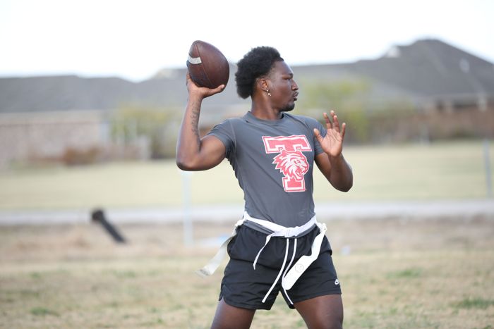 A quarterback winds up to throw