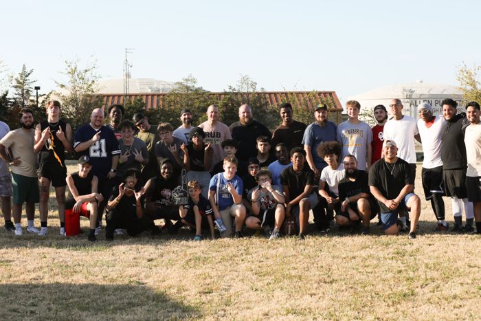 The men's flag football teams together after the game