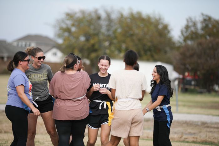 Powderpuff players laugh together between plays